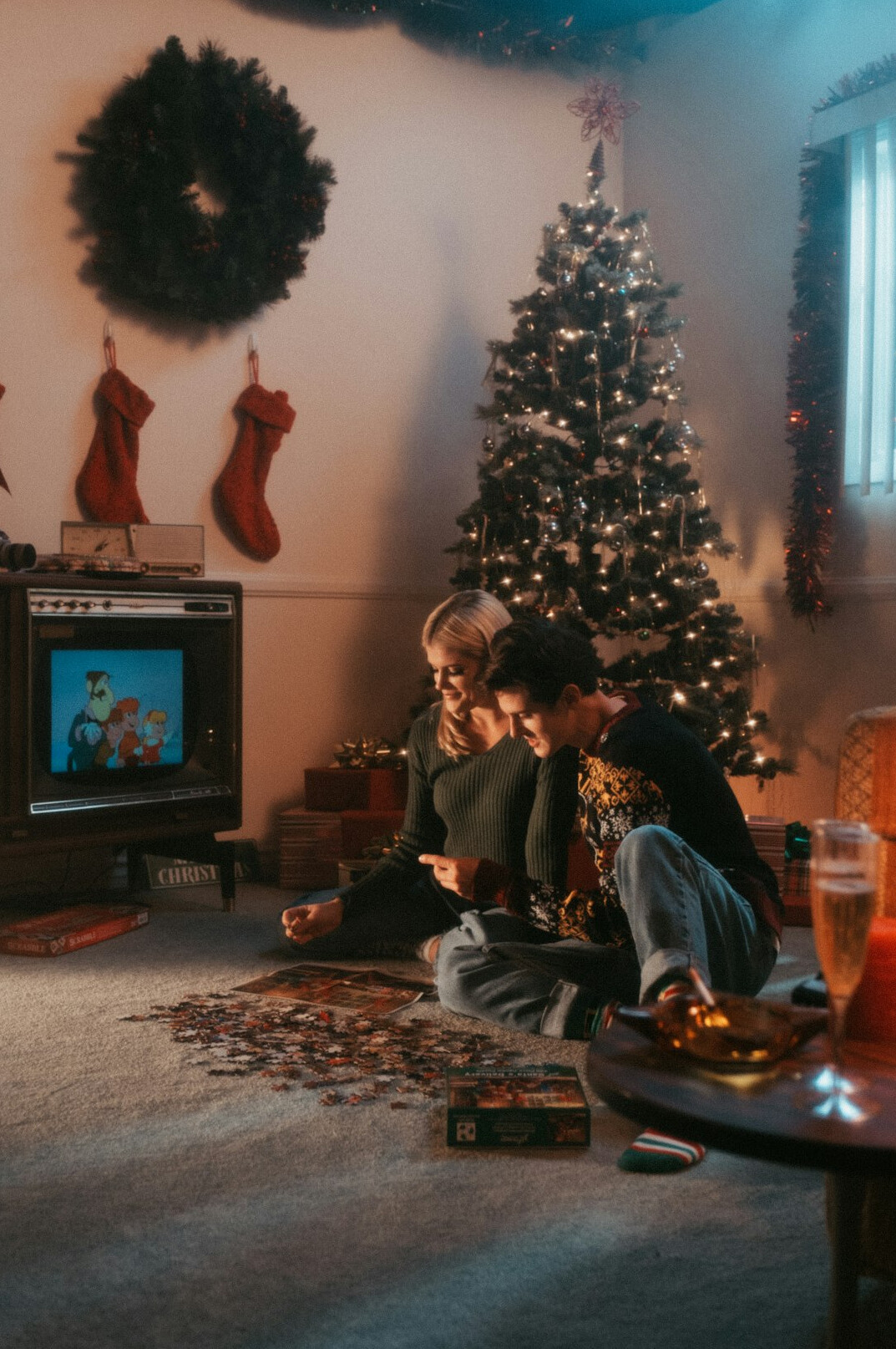 Swiss family watching television together in a 1990s living room